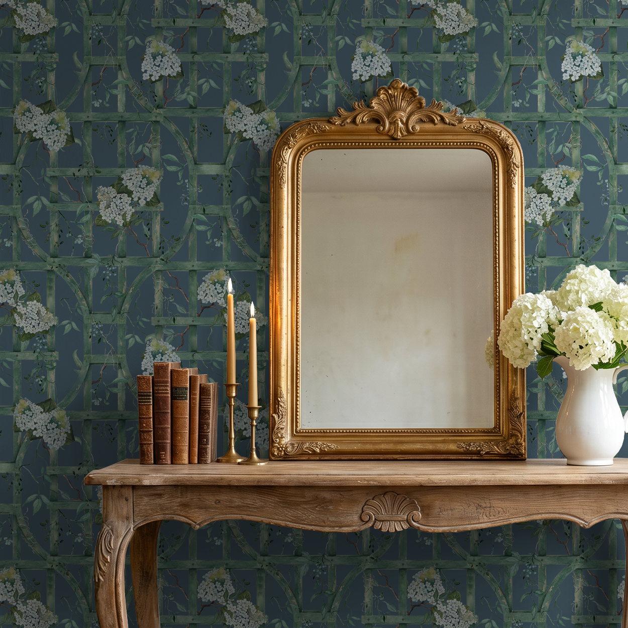 Deep blue wallpaper with green trellis and white hydrangeas behind vintage mirror and table.