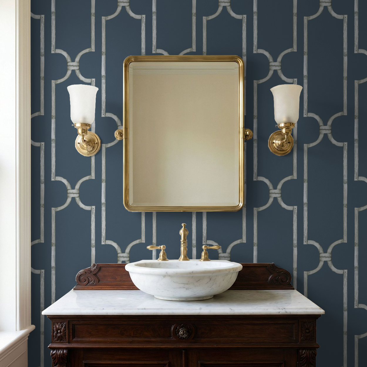 Deep blue trellis wallpaper in elegant bathroom with marble sink and gold mirror.