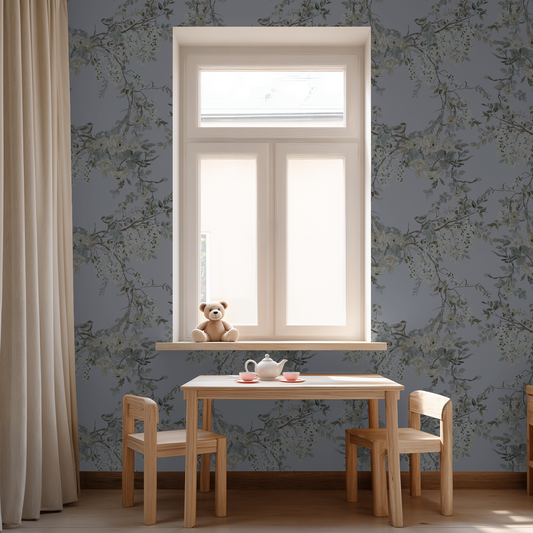 Dusty periwinkle floral wallpaper with birds in a cozy room with wooden table and teddy bear.
