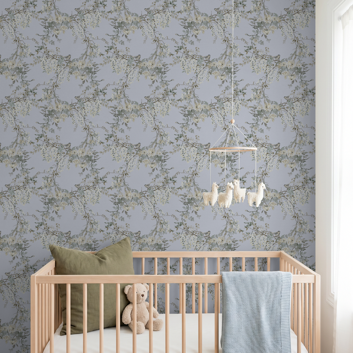Dusty violet floral and bird wallpaper in serene nursery with crib and mobile.