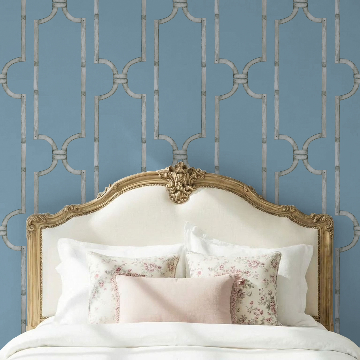 Elegant trellis pattern wallpaper in soft blue behind ornate bed