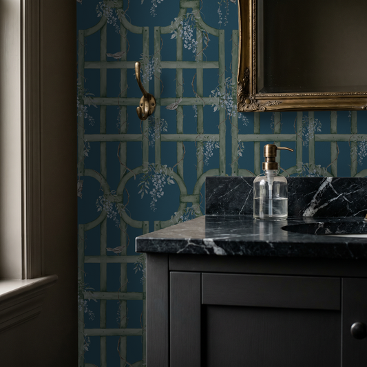 Floral trellis wallpaper in teal and sage green in a bathroom setting with marble sink.
