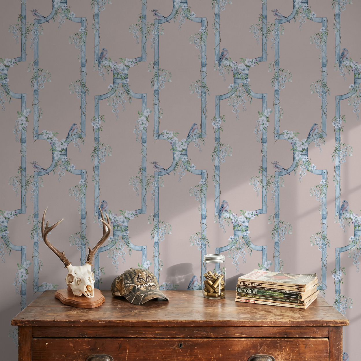 Floral wallpaper with blue birds on teal trellis in rustic room setting.