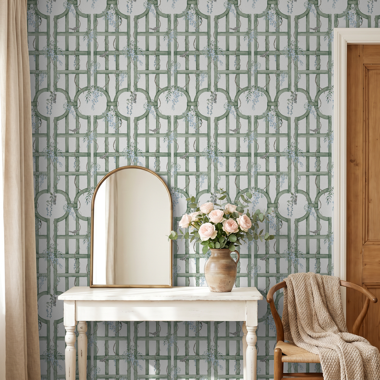 Green trellis wallpaper with blue blooms in cozy room with mirror and flowers.