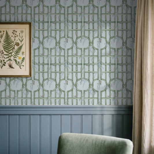 Green trellis wallpaper with blue accents in a cozy room setting