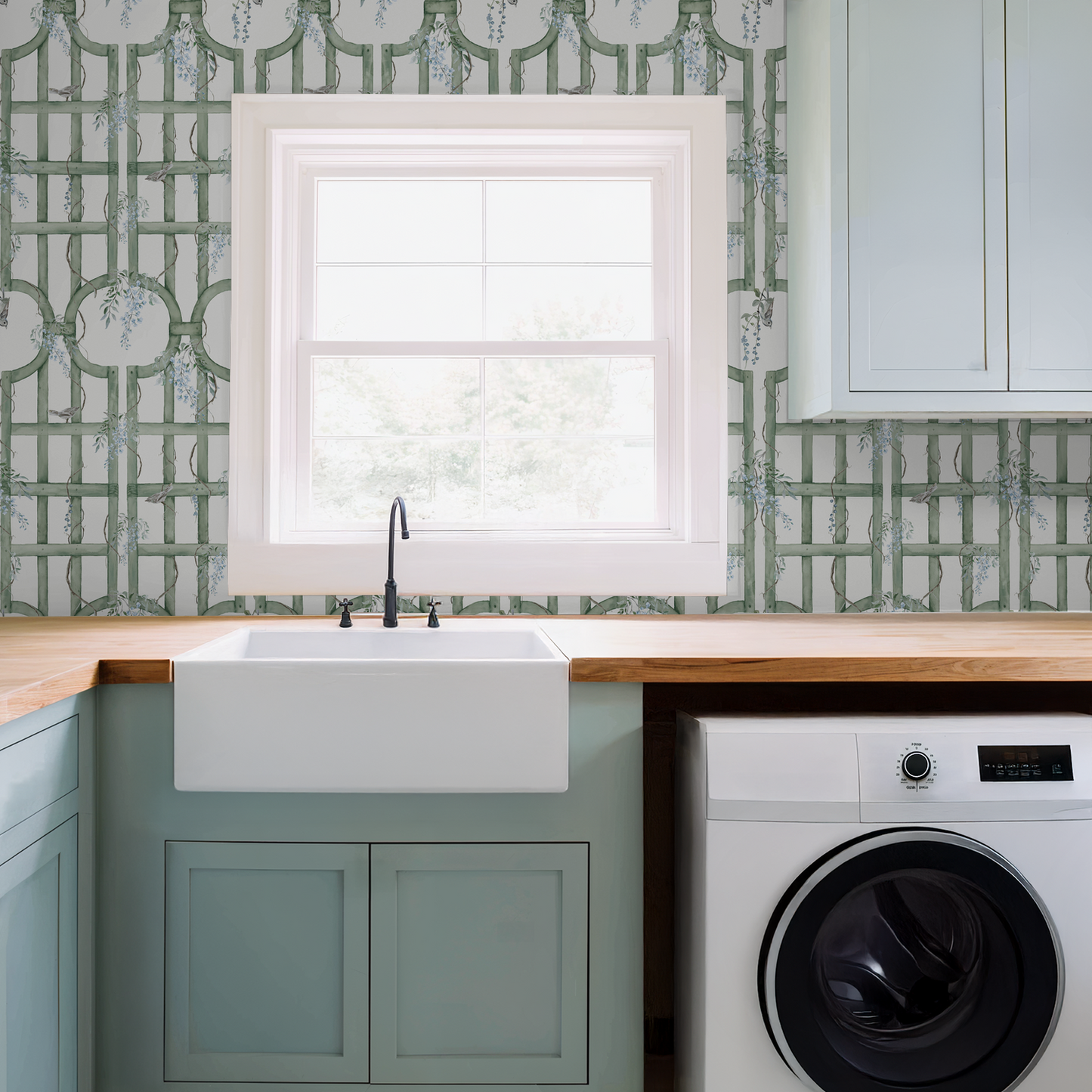 Green trellis wallpaper with blue flowers in a laundry room setting.