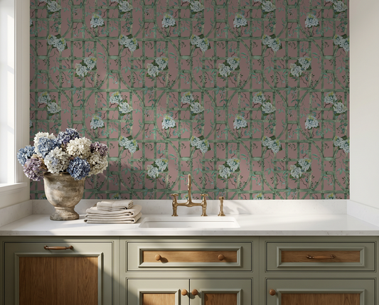 Hydrangea floral wallpaper with green trellis on deep rose in elegant kitchen setting.