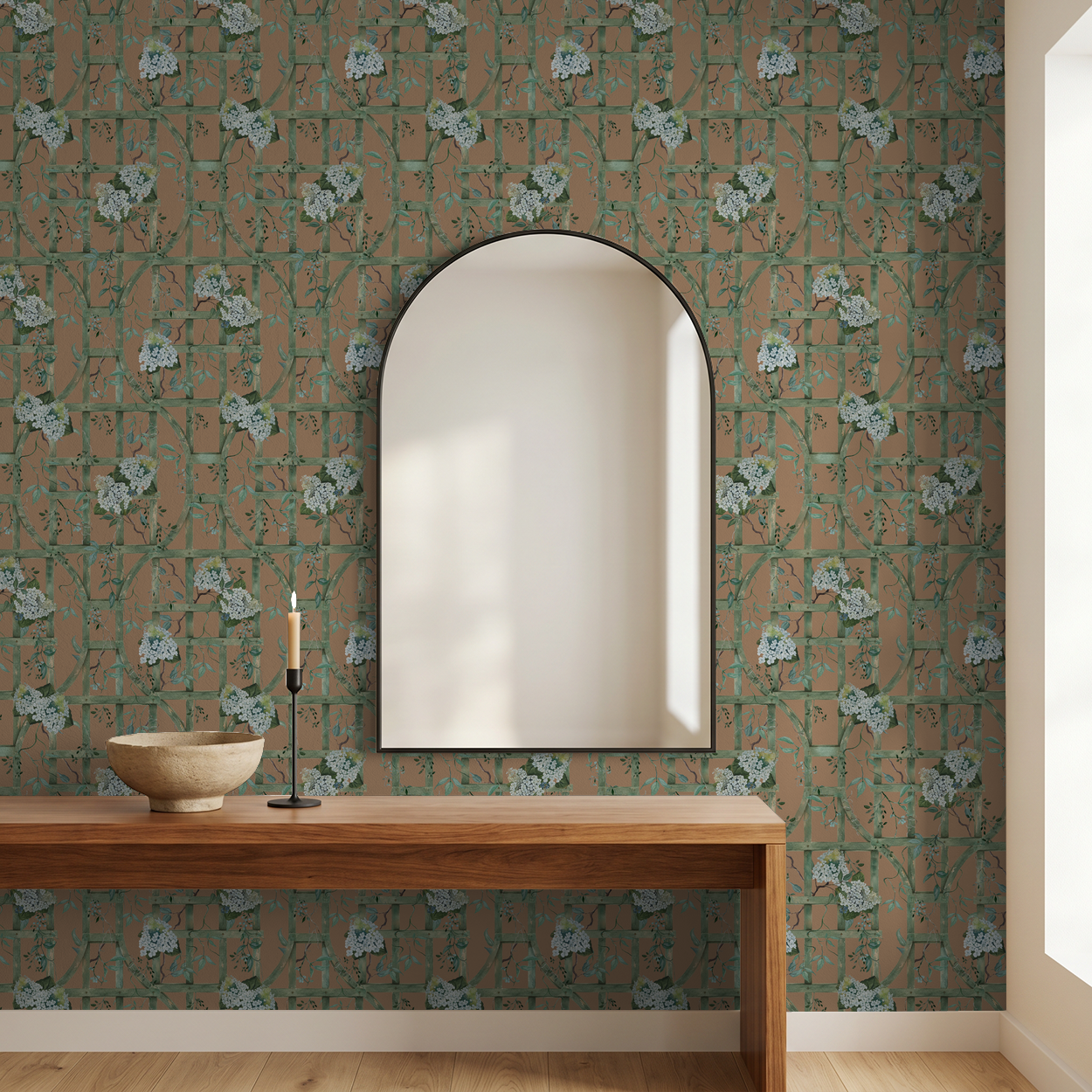 Hydrangea wallpaper with green trellis on burnt orange in modern room with mirror.