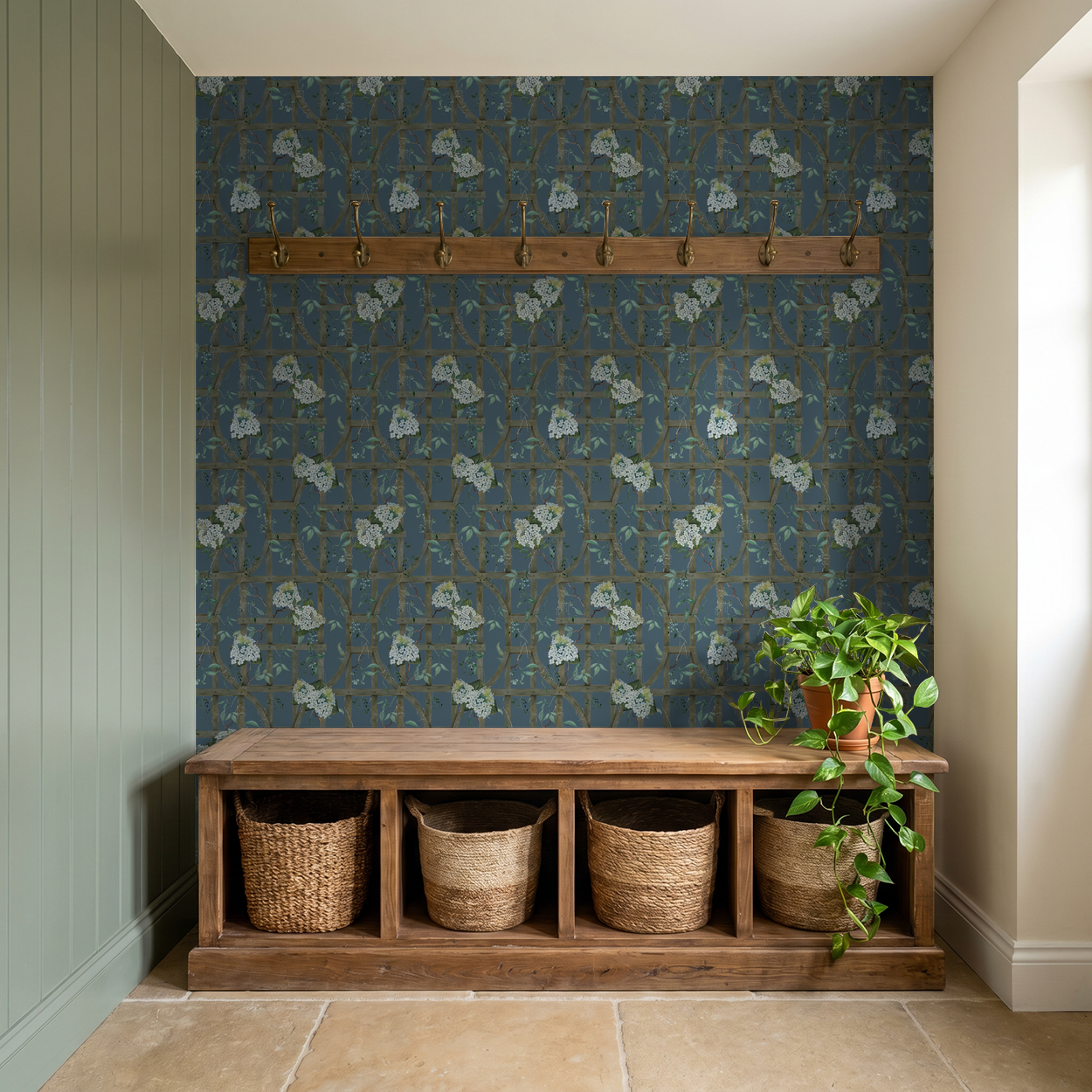 Hydrangea trellis wallpaper on deep blue in rustic entryway with wooden bench.