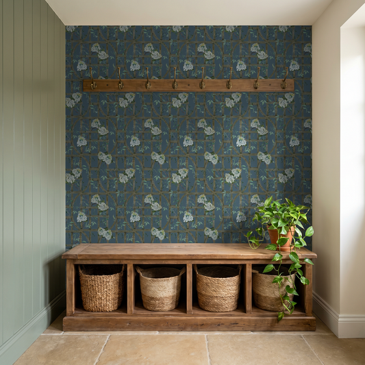 Hydrangea trellis wallpaper on deep blue in rustic entryway with wooden bench.