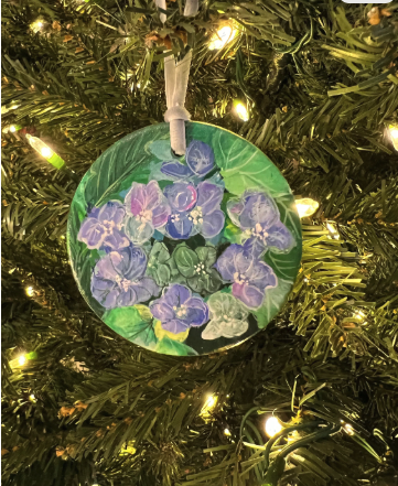 Decorative ornament with purple flowers on a Christmas tree