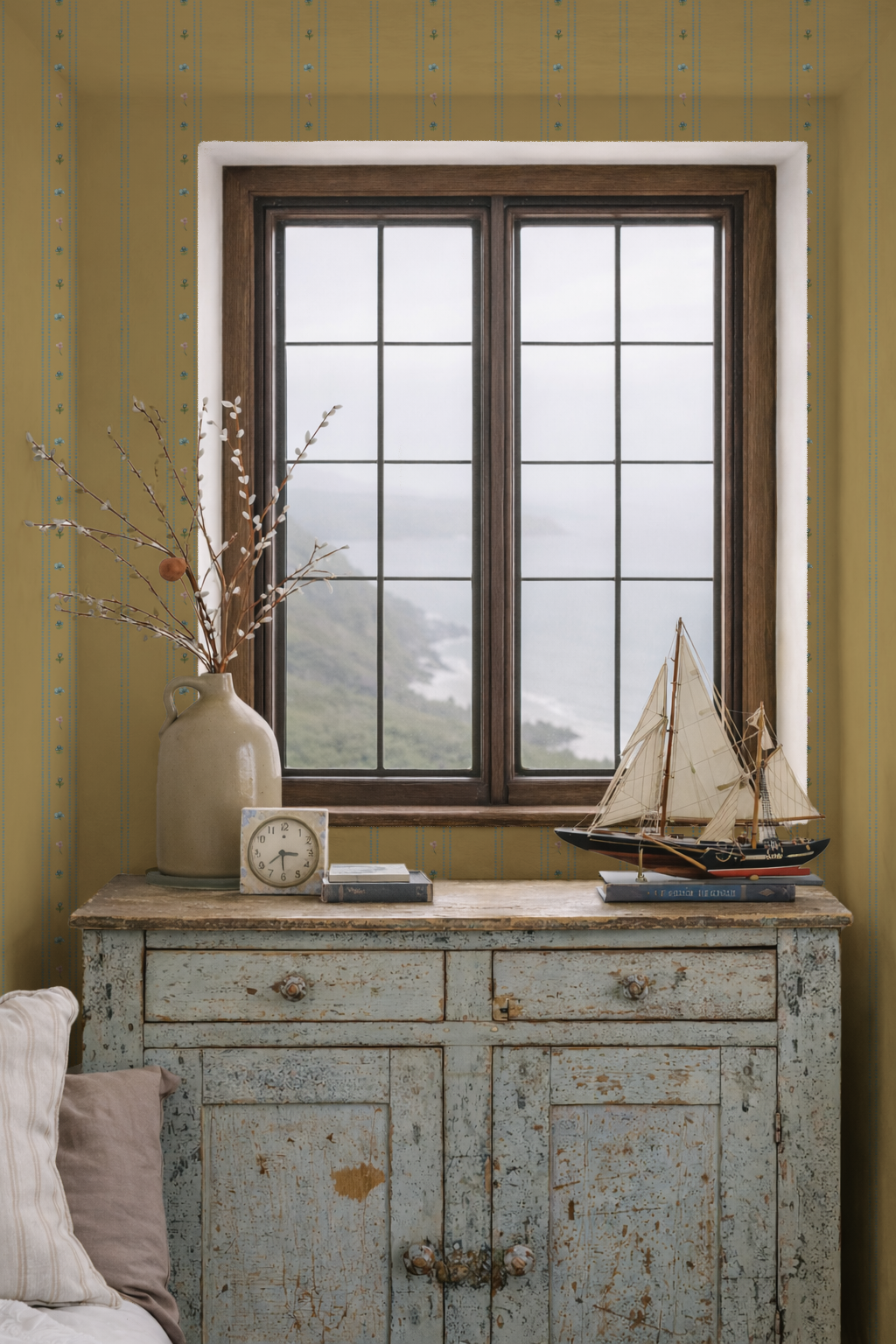 Vintage-style cabinet with decorative items against a yellow wall with striped pattern