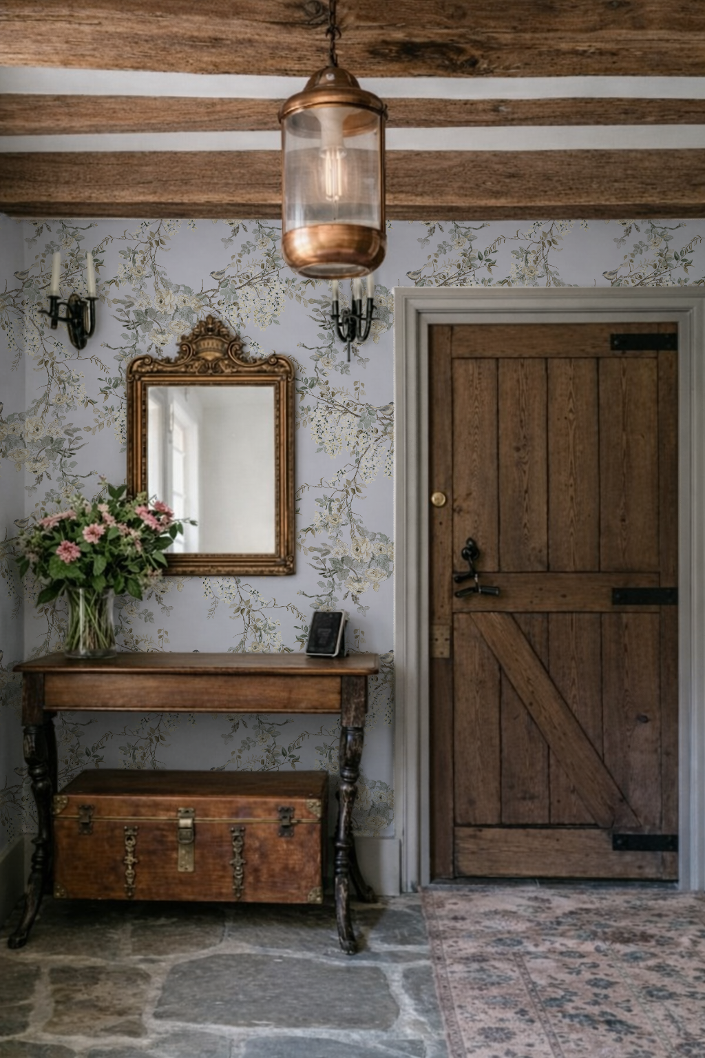 Vintage interior with wooden door, floral arrangement, and mirror.