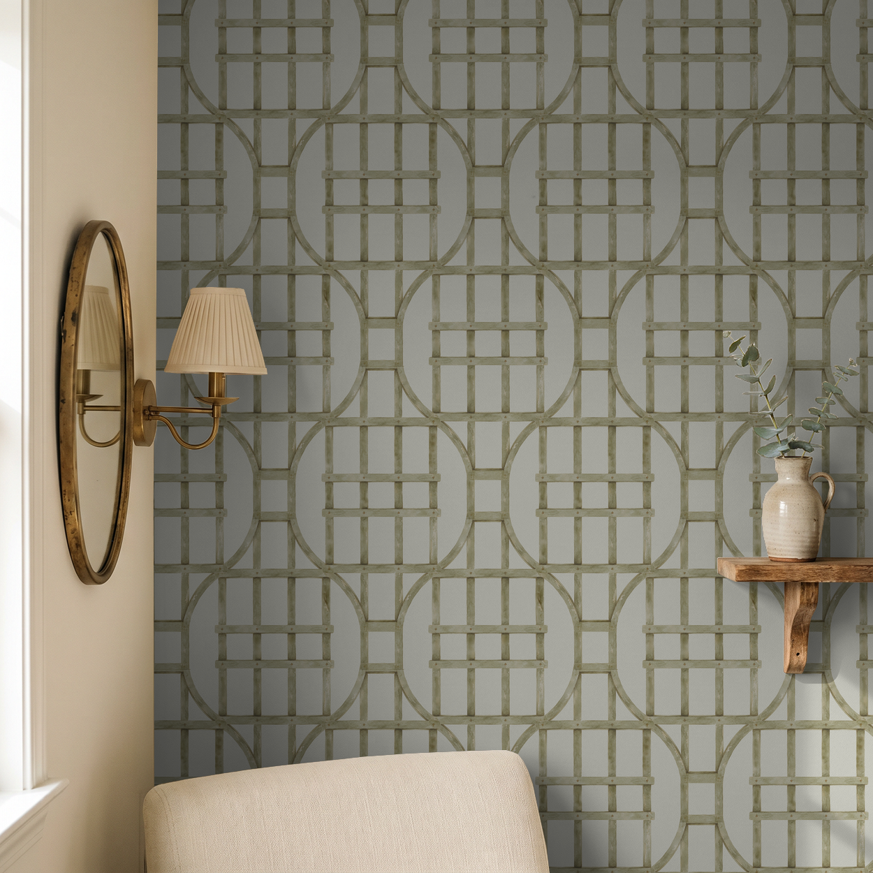 Olive green trellis pattern wallpaper in a cozy room setting with a mirror and shelf.