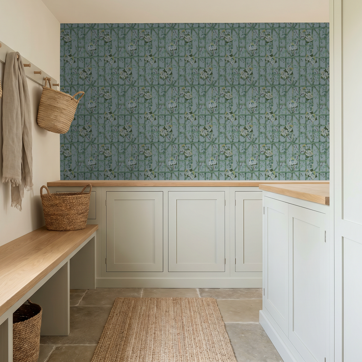 Soft blue hydrangea trellis wallpaper in rustic entryway with woven baskets.