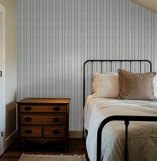 Sprite Stripe Sea Foam wallpaper in cozy bedroom with vintage furniture.