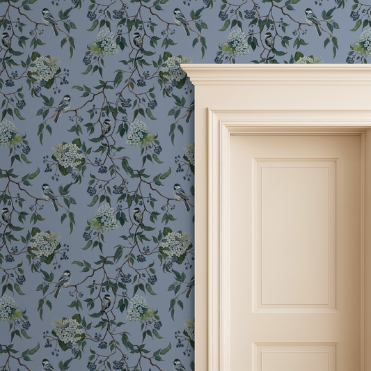 Blue-gray wallpaper with birds and floral pattern next to a cream door.