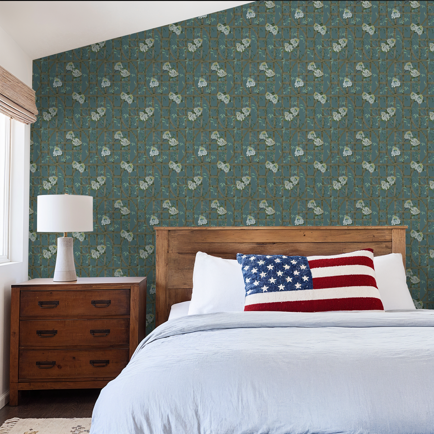 Teal floral wallpaper with hydrangea pattern in rustic bedroom setting.