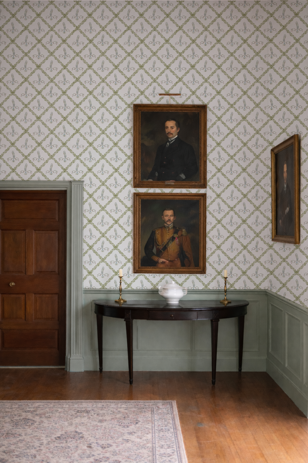 Room with ornate wallpaper, wooden furniture, and portraits on the wall.