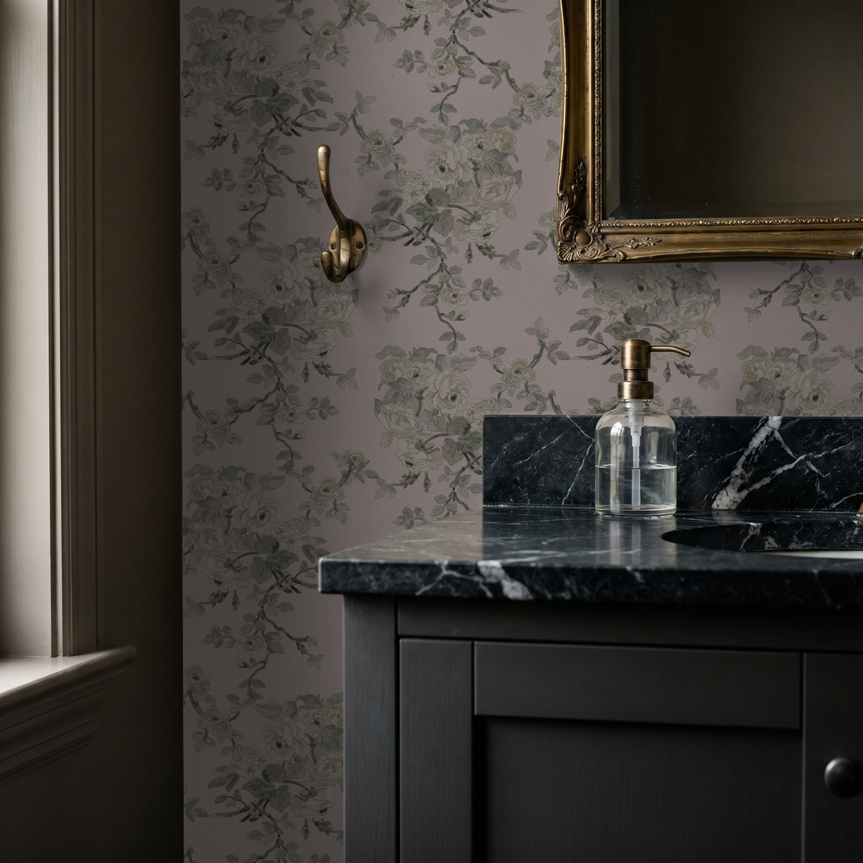 Vintage floral wallpaper in blush and sage with ornate mirror in elegant bathroom.