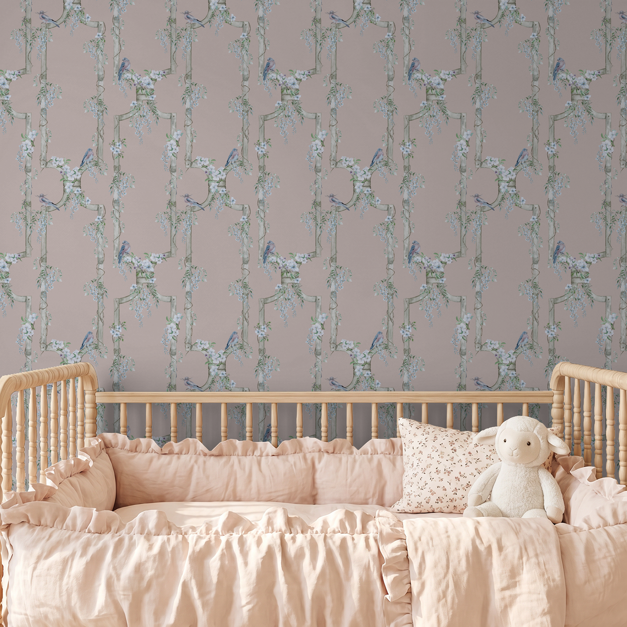 Vintage rose bird and floral trellis wallpaper in a nursery with a wooden crib.