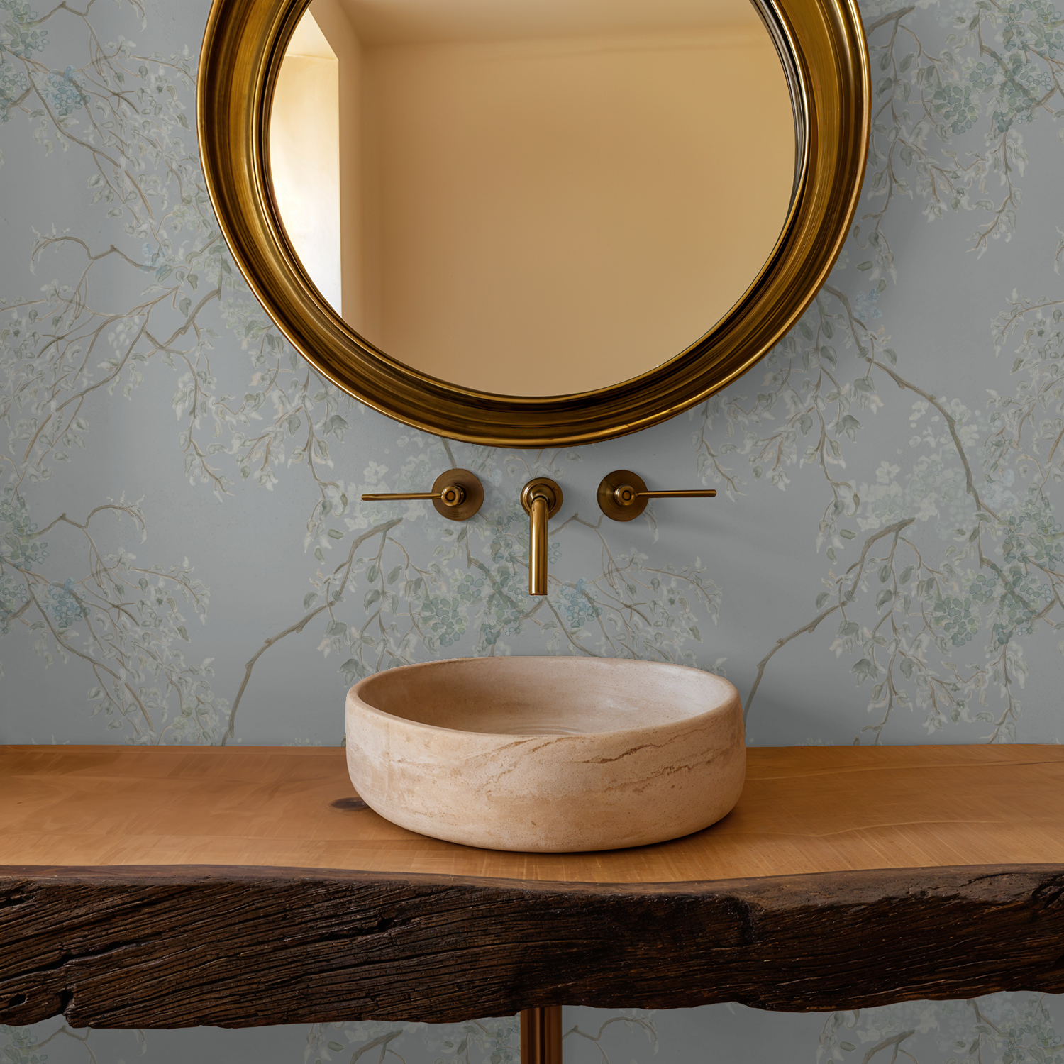 Bathroom setup with a round mirror, faucet, and stone sink on a wooden vanity.
