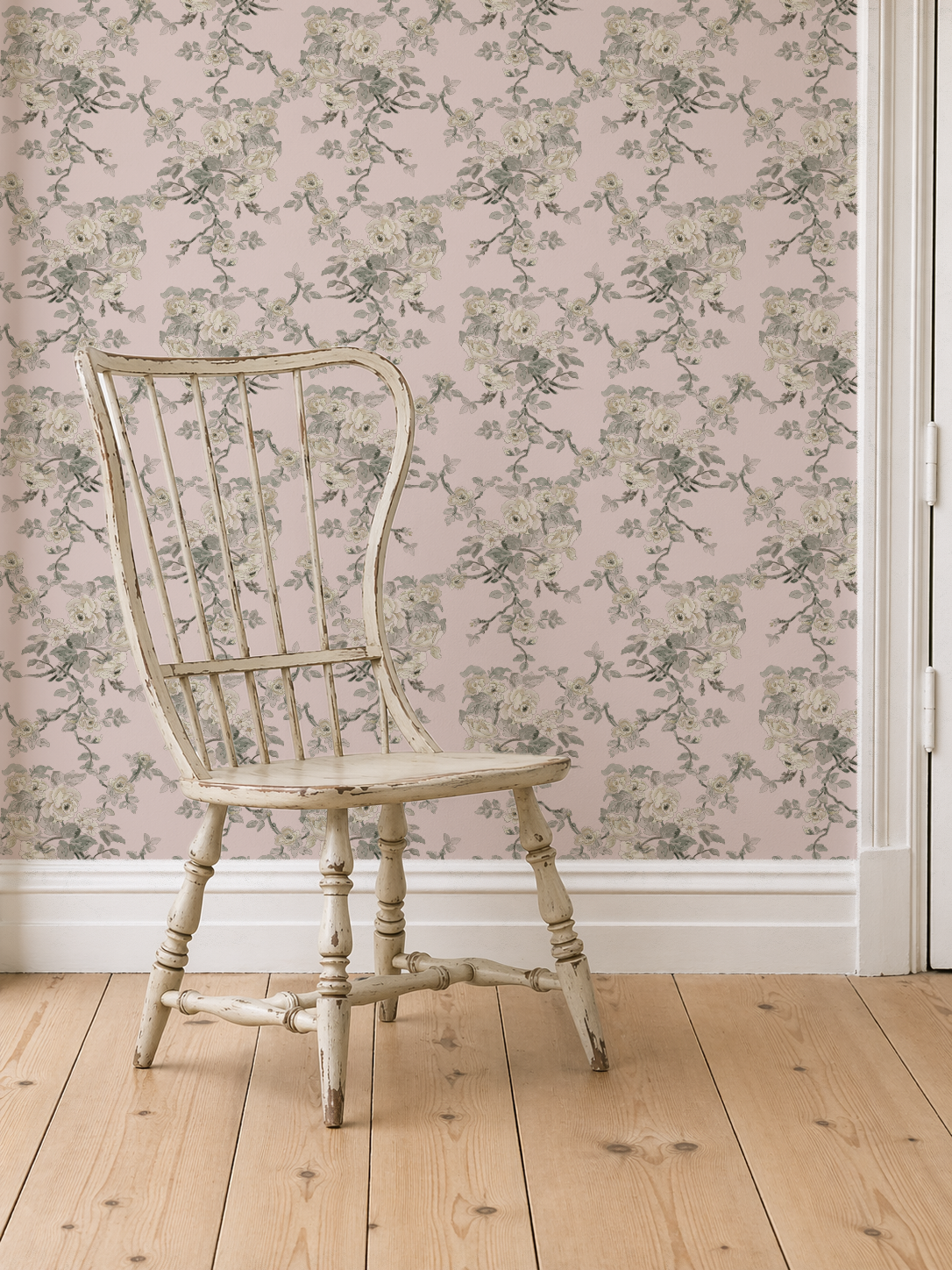 Vintage-style chair against a floral wallpapered wall.