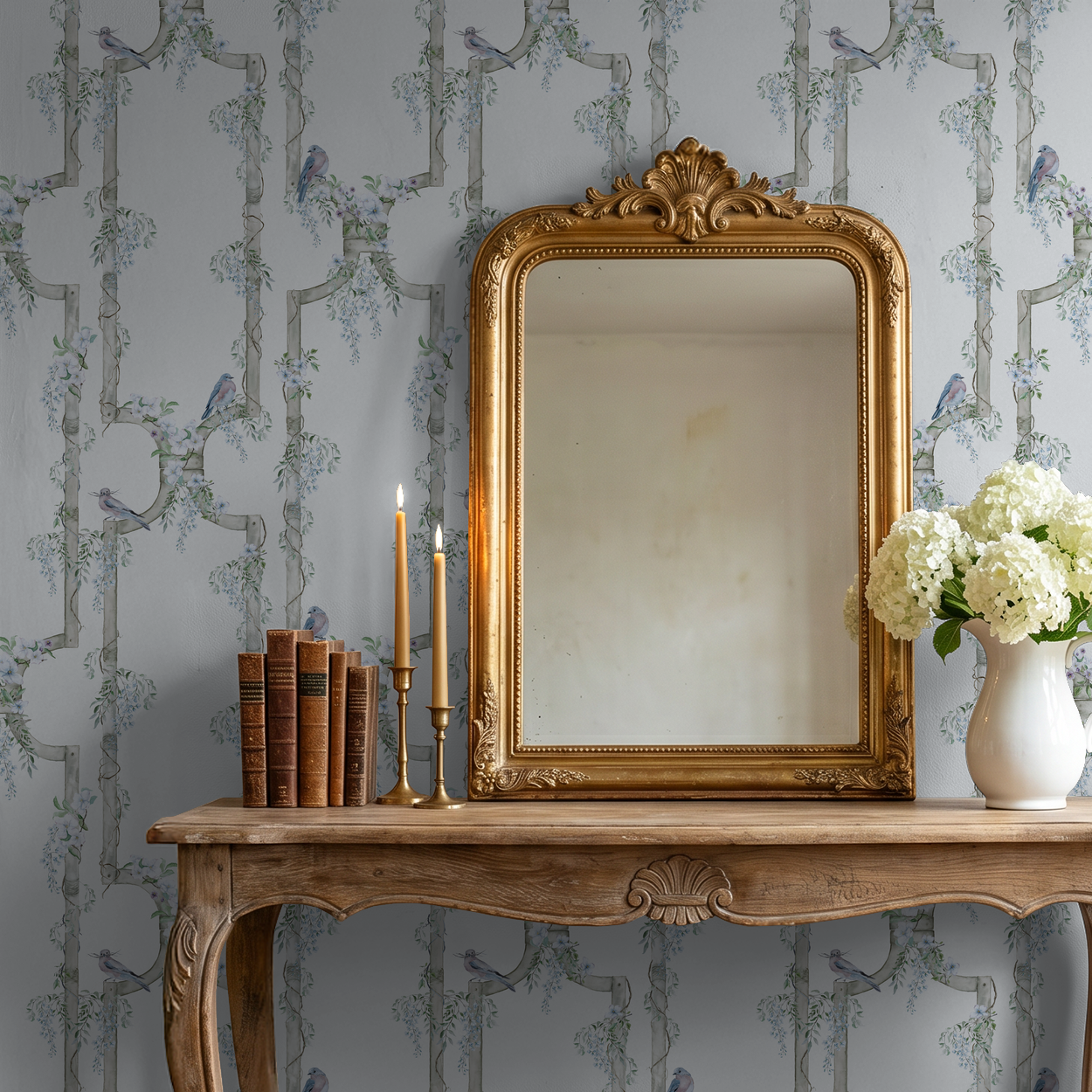 Vintage mirror with floral bird wallpaper in elegant room setting.